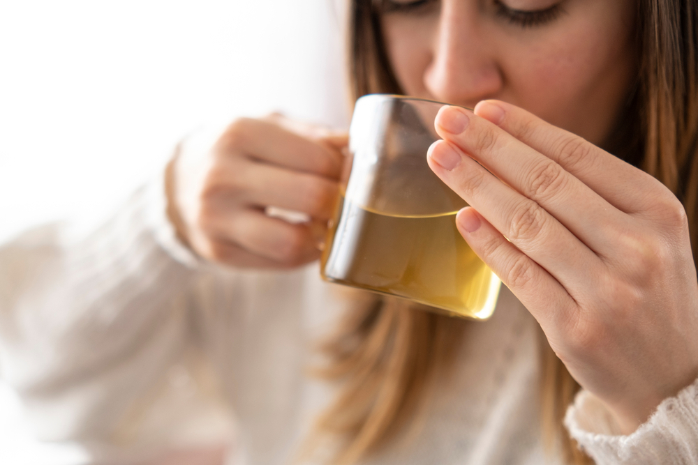 Woman,Drinking,Green,Tea,From,Transparent,Mug,In,The,Morning.healty