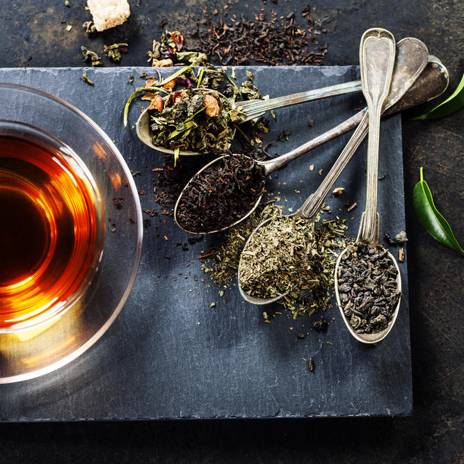 Tea,Composition,With,Old,Spoon,On,Dark,Background